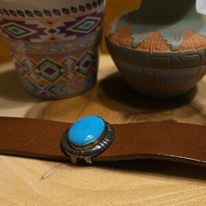 Turquoise Stone set in a Sterling Silver base,  on a  Brown Leather band.